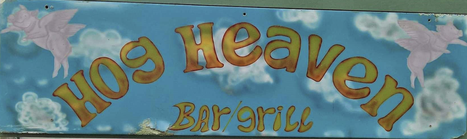The hand-painted Hog Heaven Bar & Grill sign with flying pigs